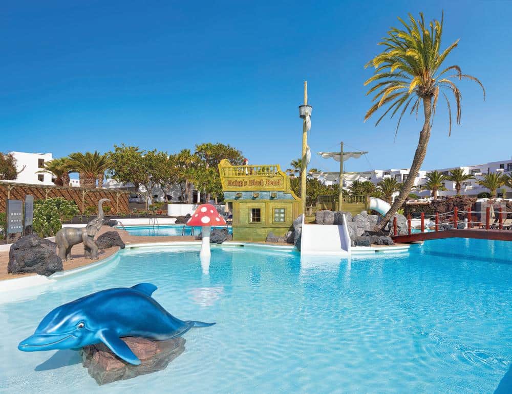 http://Piscine%20pour%20enfants%20avec%20décorations%20de%20dauphin,%20bateau%20pirate%20et%20champignon%20géant.