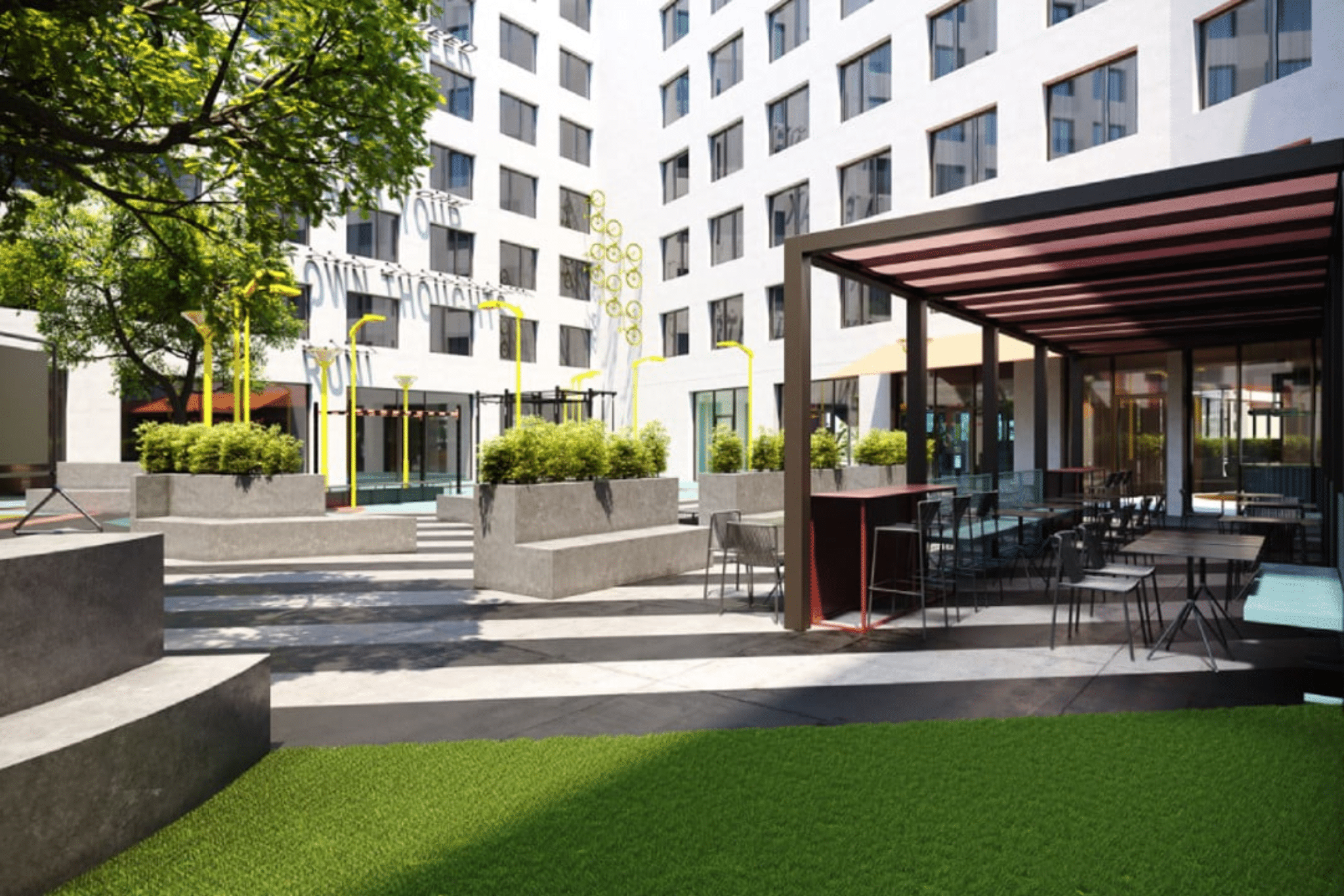 http://Cour%20intérieure%20de%20l’hôtel%20avec%20terrasse%20aménagée,%20espaces%20assis%20et%20architecture%20contemporaine