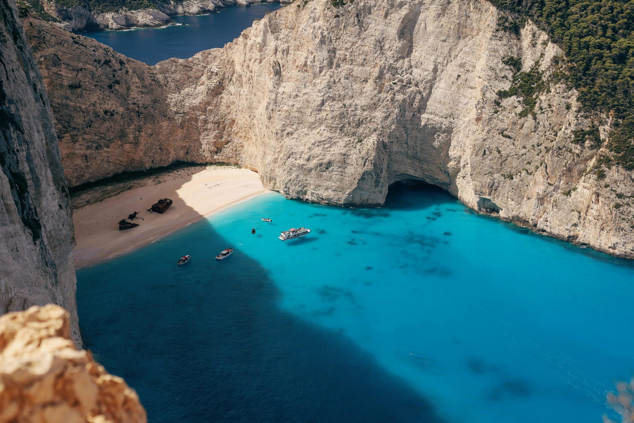 http://Vue%20aérienne%20de%20la%20plage%20de%20Navagio%20à%20Zakynthos%20avec%20falaises%20blanches%20et%20mer%20turquoise